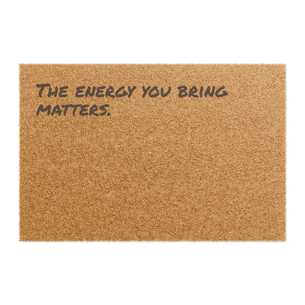 A coir doormat reading “The energy you bring matters.” against white.
