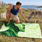 Man beside Poison & Poetry beach towel outdoors.