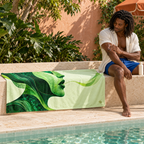 Woman beside Poison & Poetry beach towel at a pool.