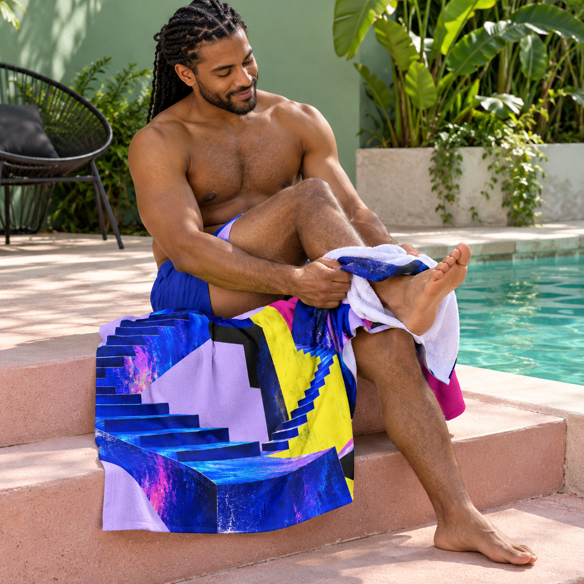 Man wearing Level Unlocked beach towel in a courtyard.