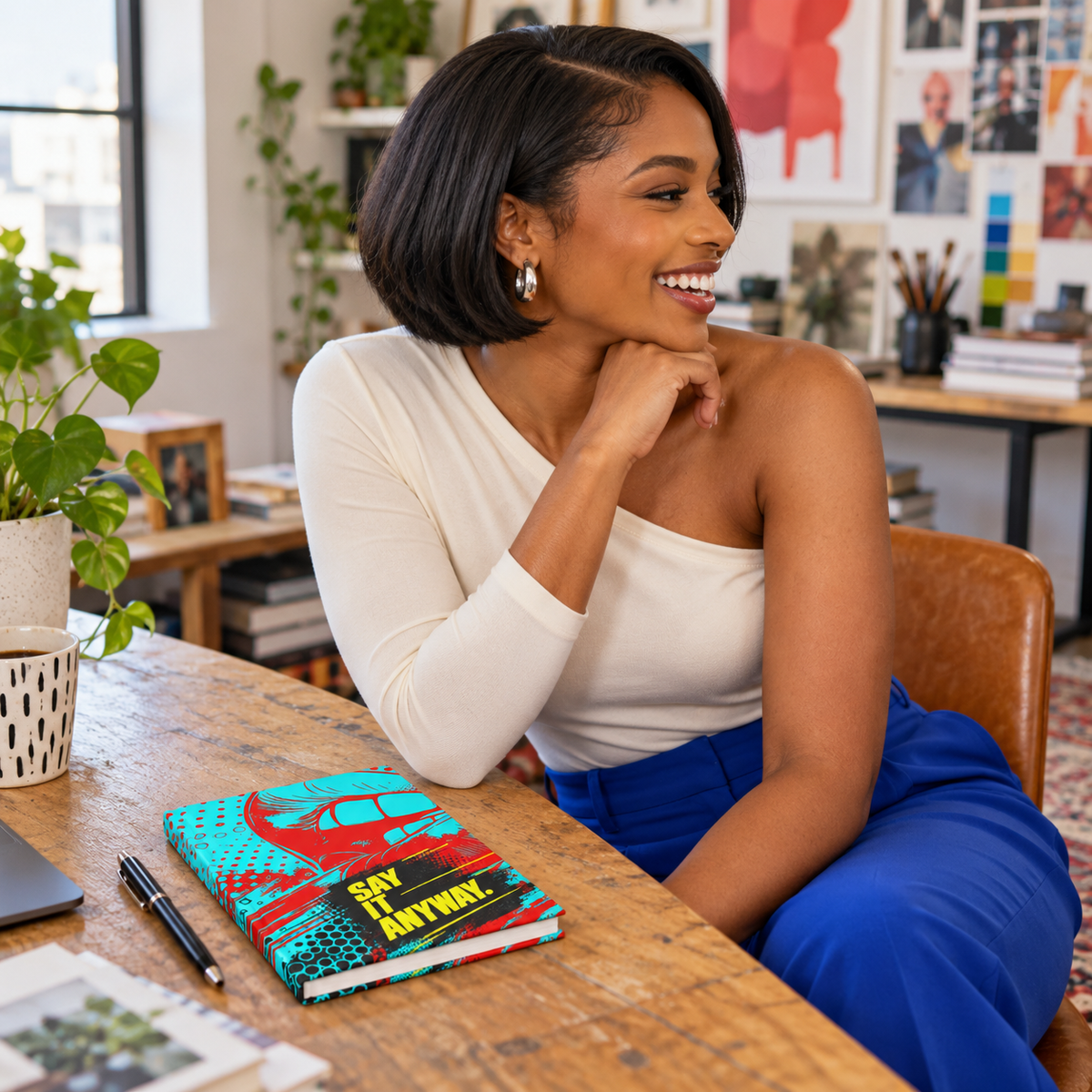 Woman with Say It Anyway journal in a design studio.