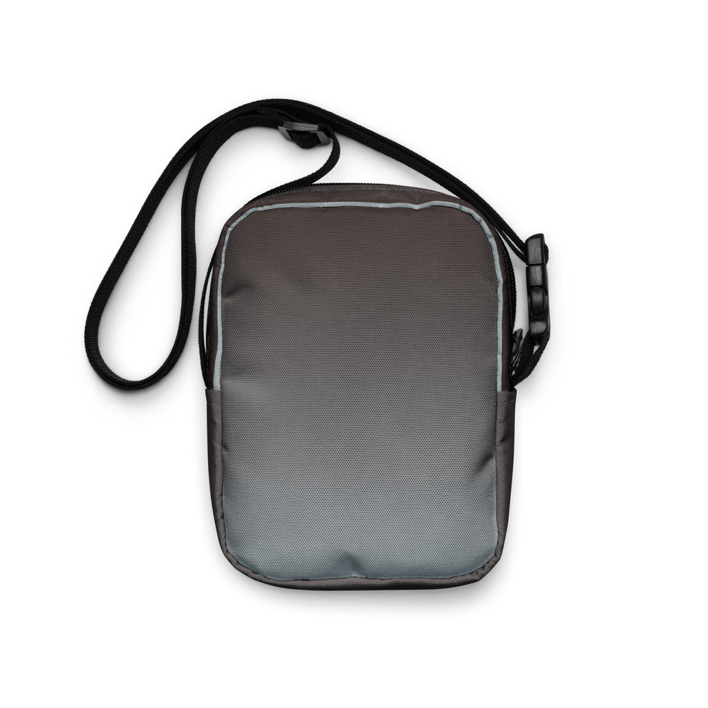 Plain gray back of the Unruly crossbody bag with its black strap.