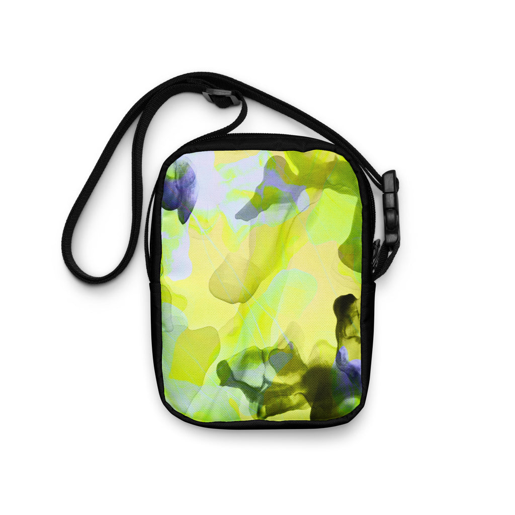 Rear view of the Personal Baggage crossbody bag with yellow-green, purple, and pale blue abstract artwork.