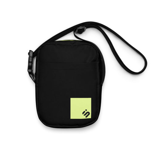 Front view of the black Off Record crossbody bag with a yellow-green monogram patch and long strap.
