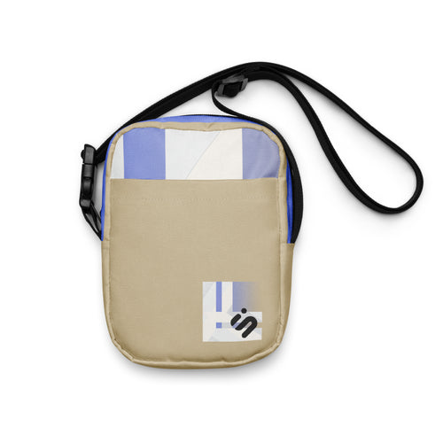 Front view of the Window Seat bag with a cream pocket, blue-and-white upper panel, and black strap.
