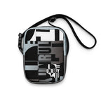 Front view of the Unruly crossbody bag with black, white, and gray geometric typography.