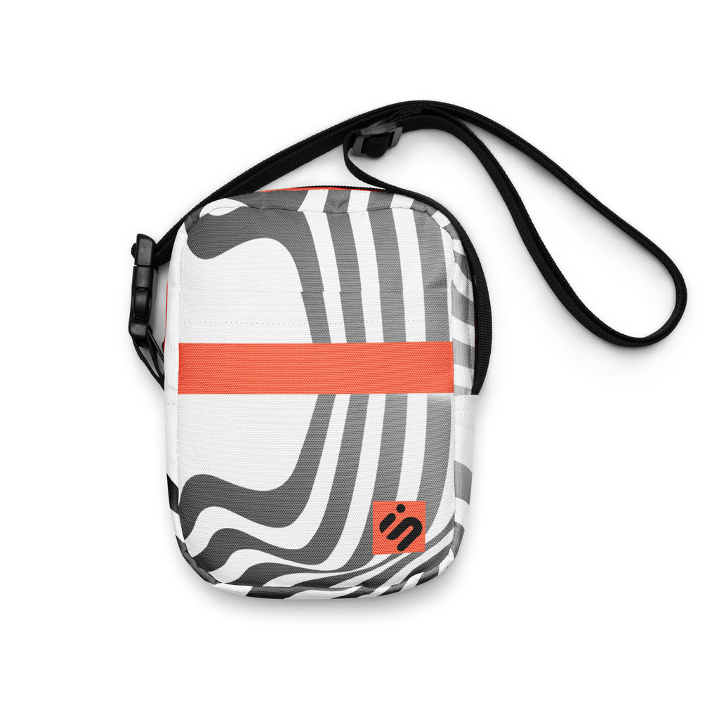 Front view of the Wrong Turn crossbody bag with black-and-white wavy stripes, an orange band, and orange monogram patch.