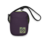 Front view of the purple Velvet Detour crossbody bag with a striped yellow-green monogram patch.