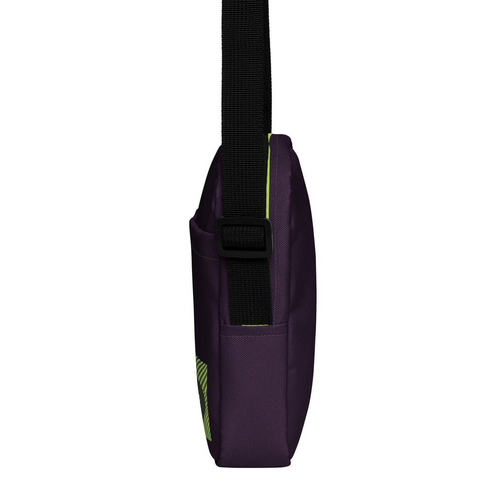 Narrow side view of the purple Velvet Detour crossbody bag showing its black adjustable strap.