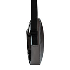 Narrow side view of the Unruly crossbody bag with its black adjustable strap.