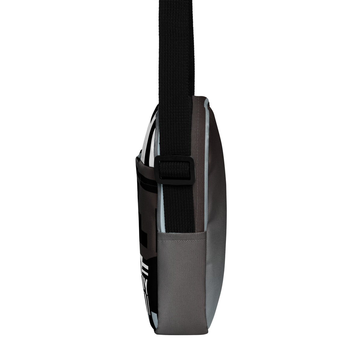 Narrow side view of the Unruly crossbody bag with its black adjustable strap.