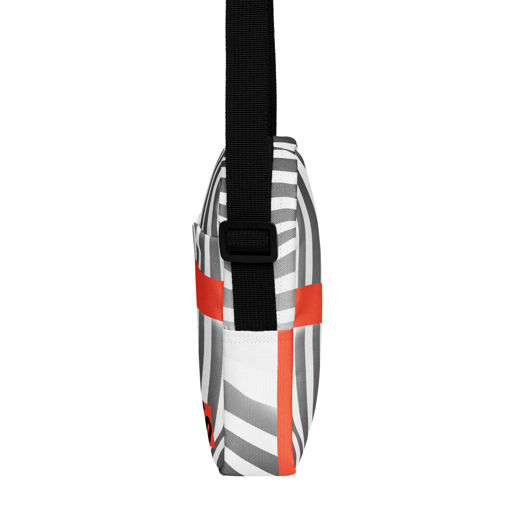 Narrow side view of the Wrong Turn bag with black-and-white stripes and orange accents.