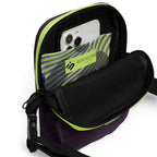 Open Velvet Detour crossbody bag with a phone in its yellow-green striped interior pocket.