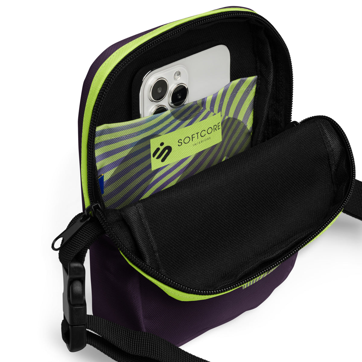 Open Velvet Detour crossbody bag with a phone in its yellow-green striped interior pocket.
