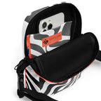 Open Wrong Turn crossbody bag showing a phone in its black-and-white patterned interior pocket.
