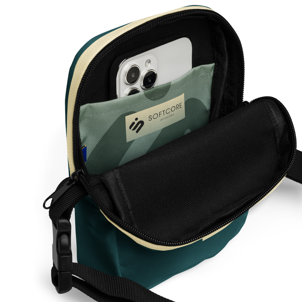 Open No Reception crossbody bag showing a phone in its green geometric interior pocket.