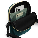 Open No Reception crossbody bag showing a phone in its green geometric interior pocket.