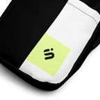 Close-up of the Personal Baggage bag's white stripe and yellow-green monogram patch on black fabric.