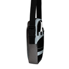 Side view of the Unruly crossbody bag showing its black buckle and gray side panel.