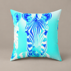 Blurred Lines faux-suede pillow with blue zebra artwork against aqua on a warm greige studio surface.