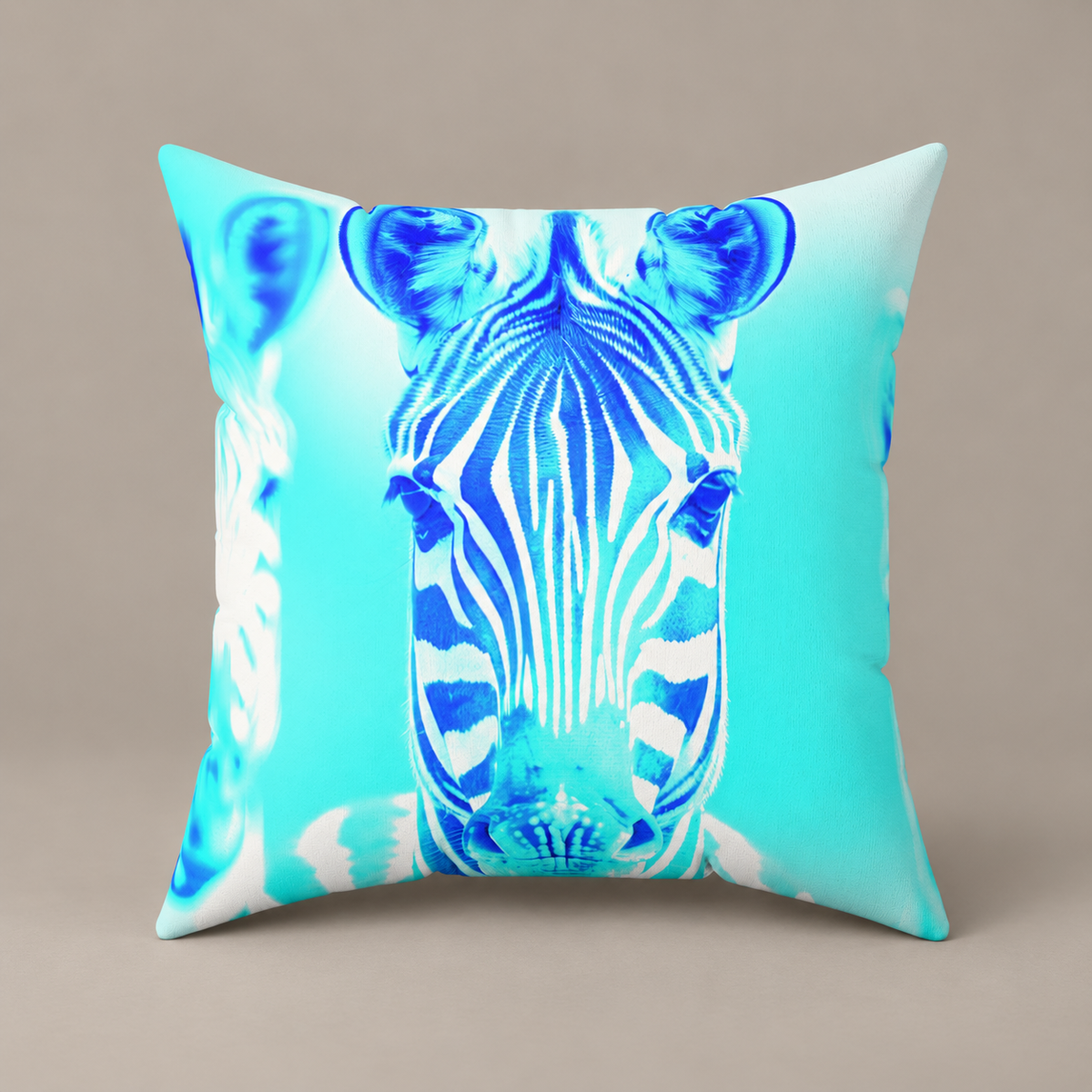 Blurred Lines faux-suede pillow with blue zebra artwork against aqua on a warm greige studio surface.