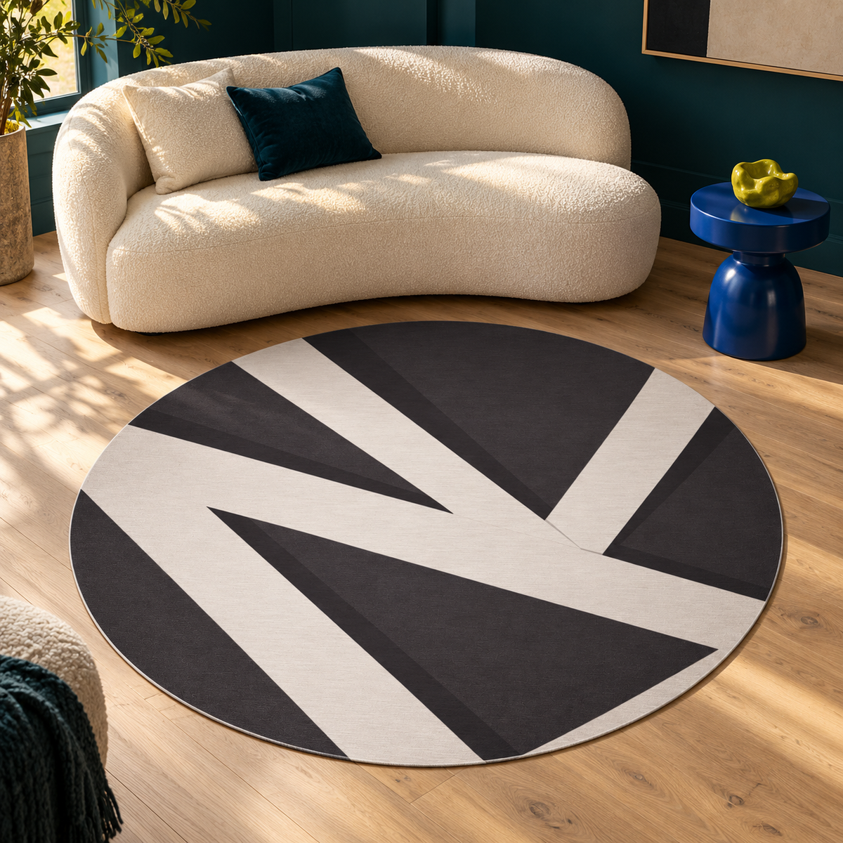 Quite Cut round charcoal-and-ivory rug in a sunlit petrol living room with an ivory sofa and blue side table.